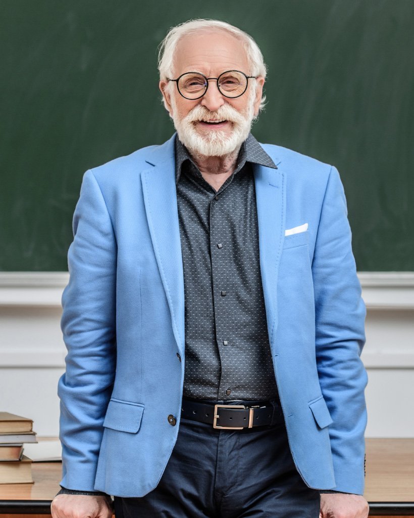 smiling grey hair professor standing in lecture ro dnul3fy.jpg