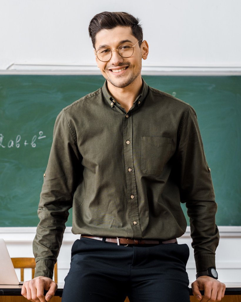 smiling male teacher in formal wear looking at cam 2nlg2e9.jpg